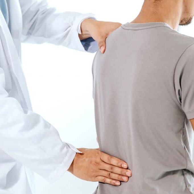 Sydney Chiropractor in Castle Hill holding the lumbar of a patient during diagnosis testing