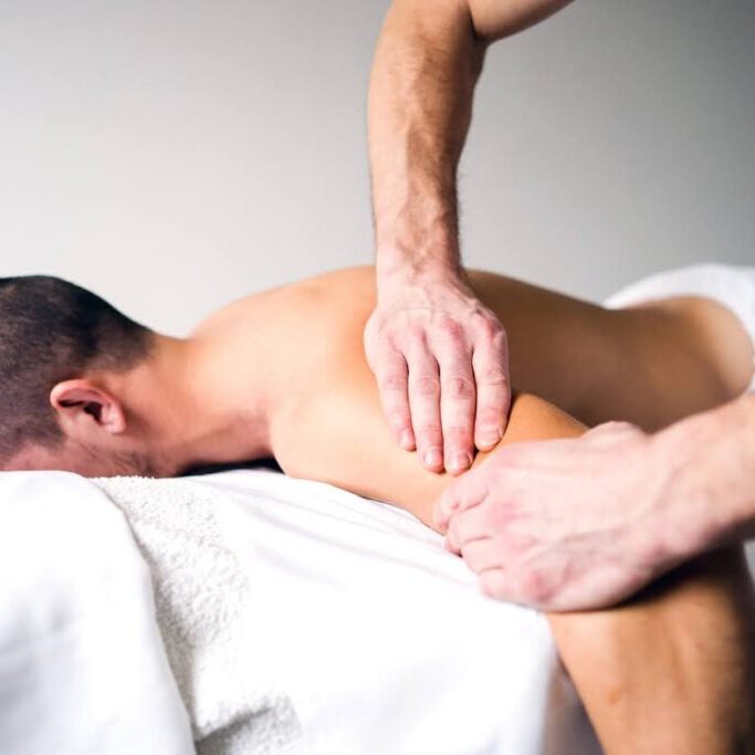 Skilled remedial massage therapist performing a targeted shoulder massage for improved mobility and comfort.